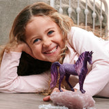 Child playing with the Schleich Galaxy Rainbow Unicorn Mare 70842 purple unicorn figure