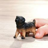 Schleich German Shepherd Puppy figure in a play scene with a child’s hand