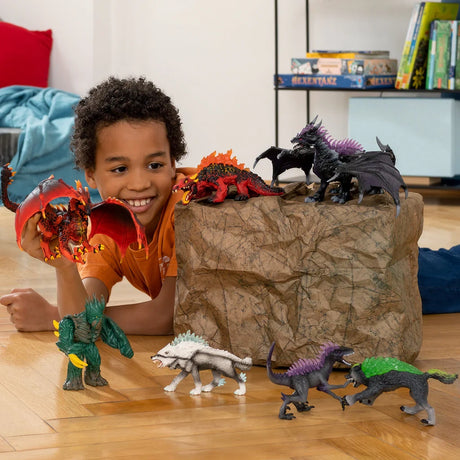 Child playing with the Schleich Jungle Emperor and several fantasy creature figures on a wooden floor