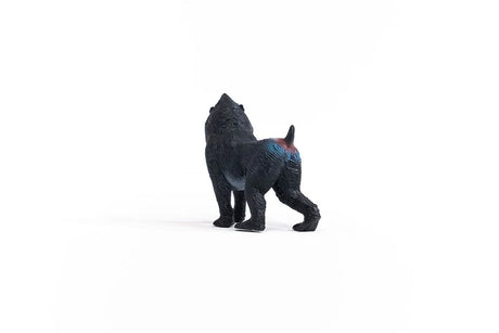 Schleich Mandrill figure with a dark textured coat, blue and red markings across the hindquarters and a short upright tail.