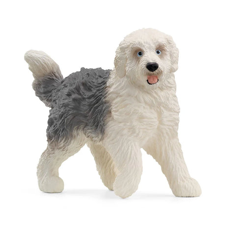 Schleich Old English Sheepdog figure with a shaggy grey and white coat, raised tail, blue eyes and open mouth