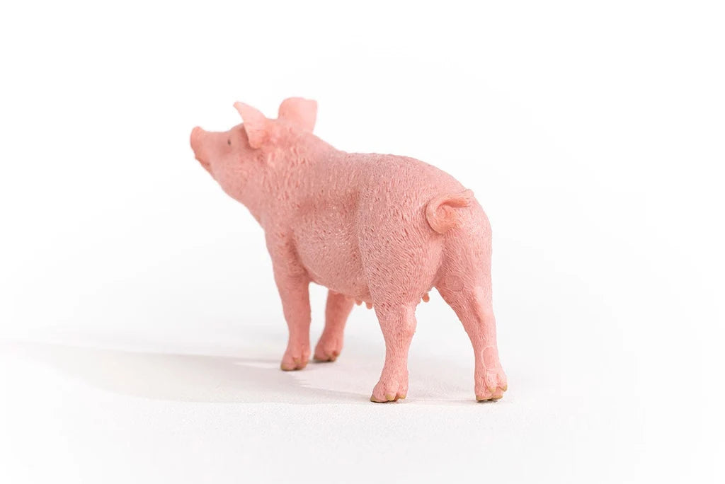 Schleich Pig figure shown from the rear left with a curled tail and textured pink body.