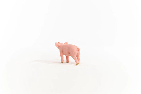 Schleich Piglet figure shown from behind with a curled tail and one rear leg extended.