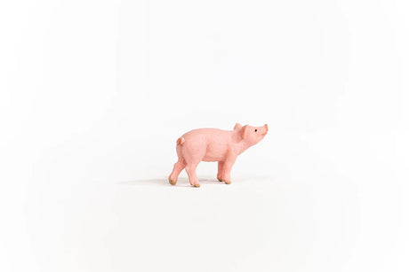 Schleich Piglet figure shown from the side with its head raised and curled tail visible.