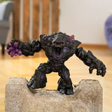 Schleich Shadow Stone Monster figure standing on a stone block with its mouth open and purple crystal fist extended