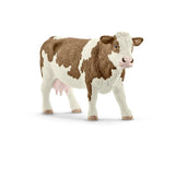 Schleich Simmental Cow figure with brown patches, white face and the front right leg stepping forward