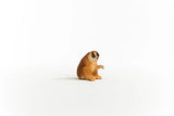 Schleich Slow Loris figure with dark eye markings, a pale face, broad feet and one hand raised. 