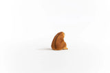 Schleich Slow Loris figure shown from the rear right with a rounded body and brown textured coat.