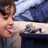 Child playing with Schleich Stone Toad 70857 with tongue extended