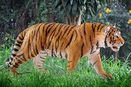 Schleich tiger figure showing realistic striping, muscular build, textured fur and a focused walking stance.