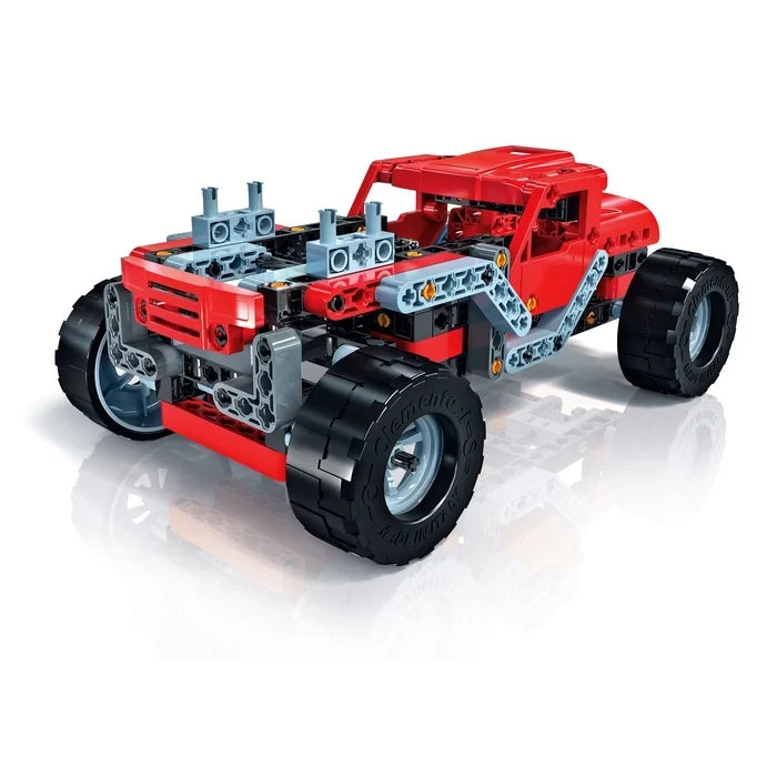 Red monster truck model with large black wheels and exposed grey and black construction pieces at the front.