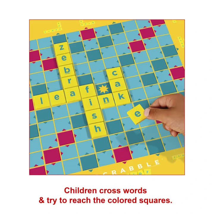 Scrabble Junior crossword board with hand placing a yellow letter tile