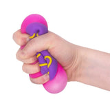 Scrunchems Donut Squishy with purple icing and pink donut being squeezed in a hand