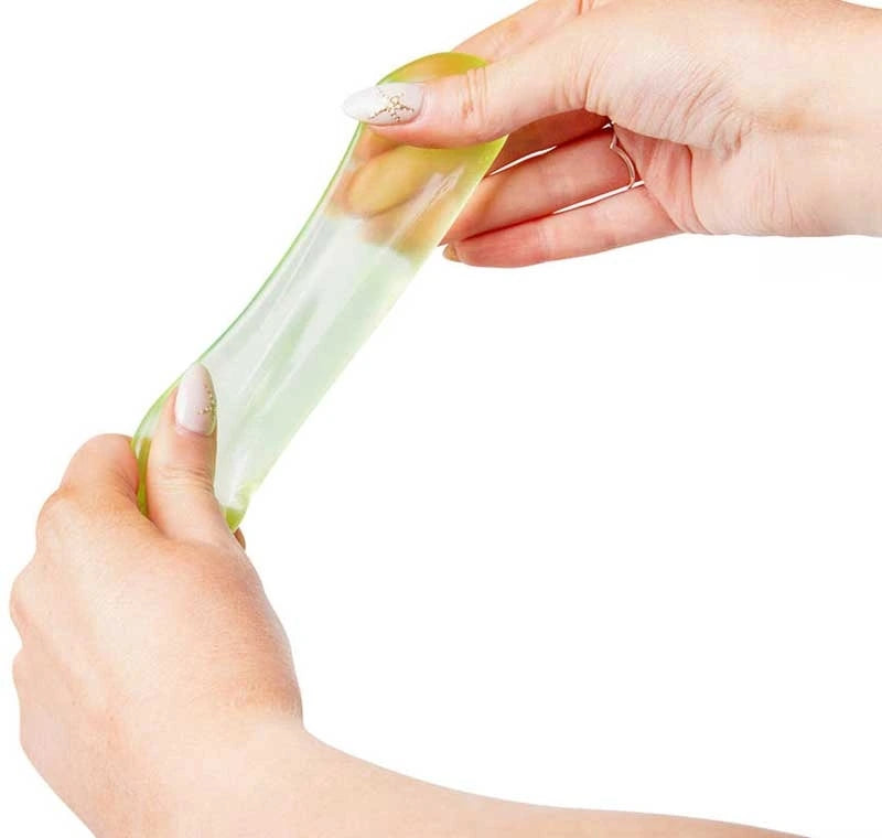 Green Scrunchems Mini Sugar Cube being stretched between two hands to show its soft flexible texture
