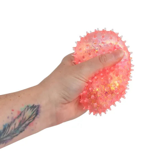 Pink Scrunchems Sensory Sugar Shape squeezed in hand showing the soft textured filling