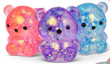Pink, purple and blue Scrunchems Sugar Bears shown together with translucent bodies, glitter filling and black facial details
