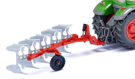 Siku full reversible plough attached to the rear of a green tractor, showing five silver ploughshares and red frame