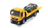 Front angled view of the Siku MAN ADAC Breakdown Truck 2722 with the green car loaded on the yellow recovery bed