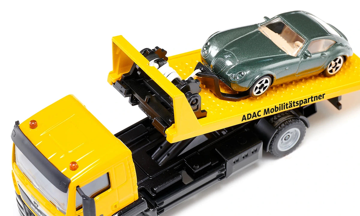 Siku MAN ADAC Breakdown Truck 2722 with the recovery platform raised and tilted while the green car remains positioned on the bed