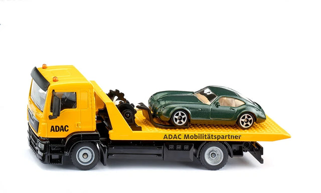 Siku MAN ADAC Breakdown Truck 2722 in side view carrying the included green car on the yellow recovery platform