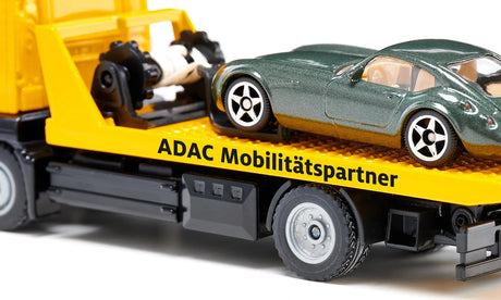 Close view of the Siku MAN ADAC Breakdown Truck 2722 showing the yellow recovery bed, cable winch assembly and green car