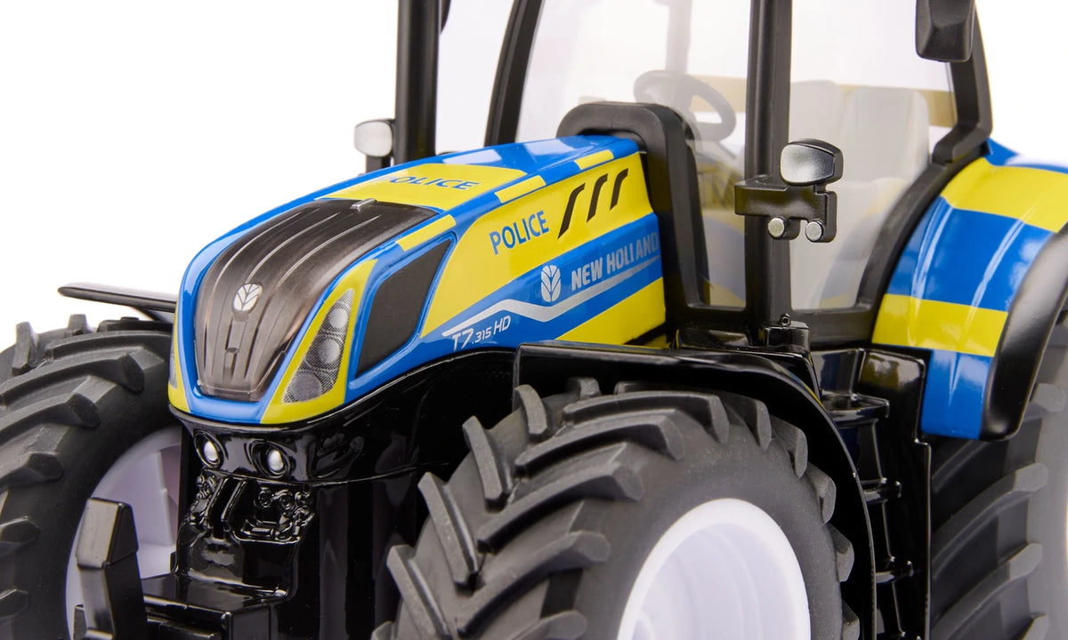 Close view of the Siku New Holland Police Tractor 3297 showing the blue bonnet, yellow Police graphics, New Holland branding and front wheel
