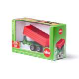 Siku tandem axle trailer displayed inside green Siku Farmer retail box with clear window showing the red trailer and twin axle wheels