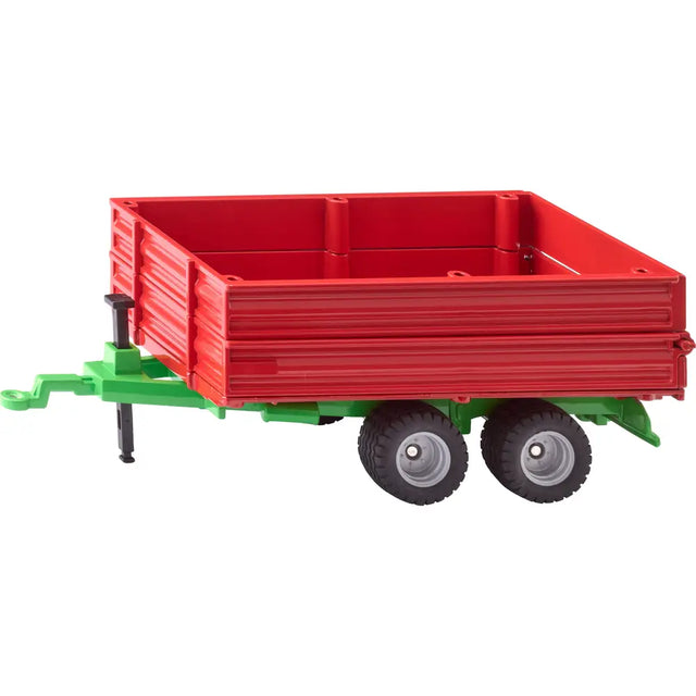 Siku tandem axle trailer shown from side view with red trailer bed, green chassis, drawbar hitch and twin axle wheels on white background