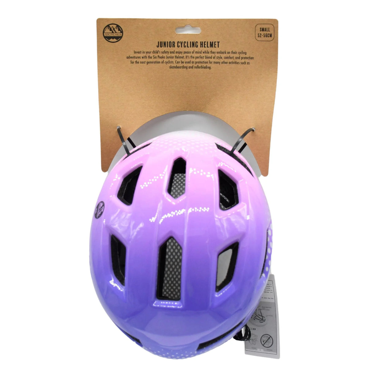 Pink and purple junior cycling helmet mounted on branded cardboard backing card, top view showing ventilation slots