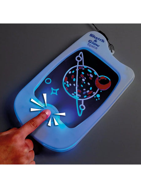 Child touching illuminated Sketch and Glow Space drawing pad with colourful space sketch