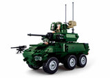 Sluban MB-EBRC 6x6 Wheeled Infantry Combat Vehicle shown from the front side with angular green bodywork, six wheels, turret cannon, upper weapon details, two soldier figures and separate mounted machine gun