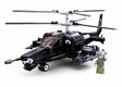Sluban Model Bricks KA-50 Black Shark helicopter shown from the front side with clear cockpit, twin rotor assembly, nose gun, side mounted rocket pods, landing gear and pilot figure
