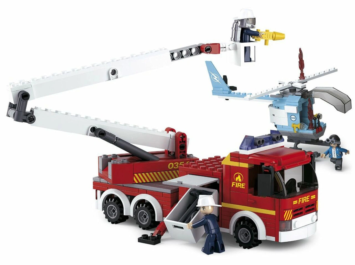 Sluban fire rescue construction set showing the red platform fire truck, articulated white aerial ladder with firefighter platform, blue helicopter and three firefighter figures