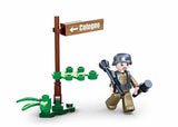 Sluban WWII M5 Light Tank soldier figure beside a Cologne signpost and small plant pieces