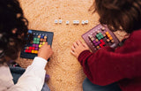 Children playing Genius Square puzzle game together indoors Ireland