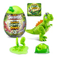 Green plastic T-Rex dinosaur figure next to disassembled green parts and Mystery Egg packaging panel, on plain white background