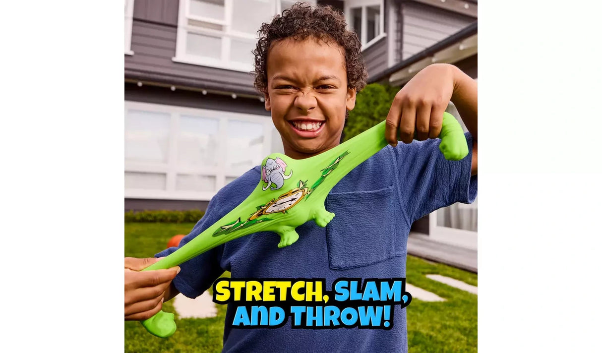 Child pulling the green elephant faced Smashers Brain Rot figure into a wide stretched shape outdoors