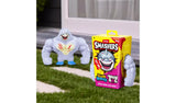 Grey shark faced Smashers Brain Rot figure standing beside its yellow retail pack on grass