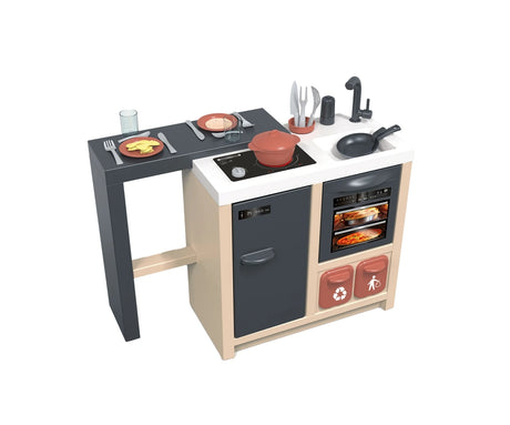 Smoby Kitchen Island play kitchen with grey dining counter, white sink, black hob, oven, fridge, cooking pot, frying pan, plates and utensils on a white background.