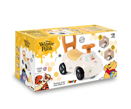 Smoby Winnie the Pooh Auto Ride On retail packaging featuring the white ride on car, Disney Winnie the Pooh branding, illustrations of Tigger and Pooh, and product photographs.