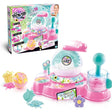 So Bomb DIY Flower Bath Bomb Factory retail box beside the pink and turquoise mixing machine, with flower shaped bath bombs, coloured bath crystals, moulds and accessories on a white background.