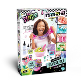 So Slime Experience Deluxe Set Pop Style retail box viewed at an angle, showing a girl stretching pink slime and illustrations of colourful slime mixtures and decorations.
