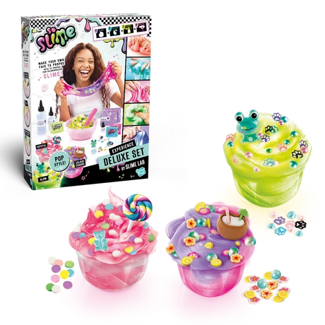 So Slime Experience Deluxe Set Pop Style retail box displayed alongside three finished pink, green and purple slime pots decorated with sweets, a frog charm, paw prints, flowers and a coconut drink.