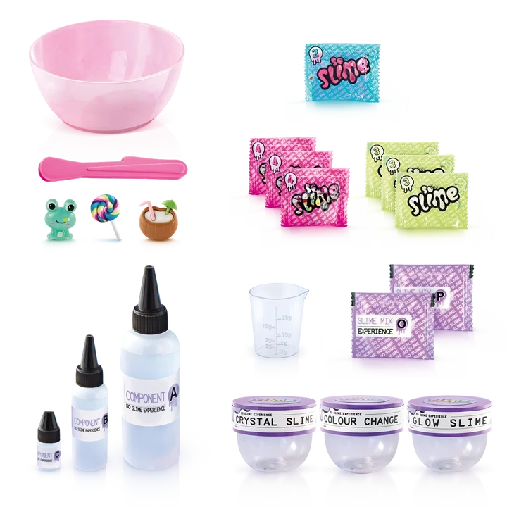 So Slime Experience Deluxe Set Pop Style contents laid out, including a pink mixing bowl, spatula, ingredient bottles, measuring cup, slime powder sachets, decoration packets, miniature charms and three clear storage pots labelled Crystal Slime, Colour Change and Glow Slime.