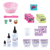 So Slime Experience Deluxe Set Pop Style contents laid out, including a pink mixing bowl, spatula, ingredient bottles, measuring cup, slime powder sachets, decoration packets, miniature charms and three clear storage pots labelled Crystal Slime, Colour Change and Glow Slime.