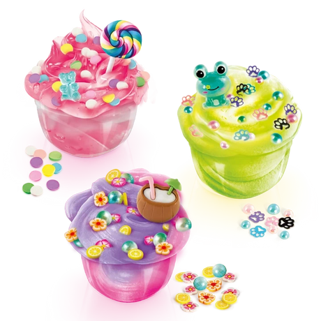 Three decorated So Slime Pop Style creations in clear pots: pink slime topped with a rainbow lollipop and sweets, green slime with a frog charm and paw prints, and purple slime with a coconut drink decoration.