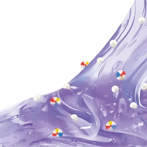 Close-up of transparent purple So Slime Pool Party slime stretched across a white background, containing small colourful beach ball decorations and white foam beads.