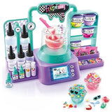 So Slime Experience Lab with turquoise and purple electronic laboratory, mixing bowl containing pink slime, ingredient bottles, slime containers, colourful decorations and two finished slime pots with miniature charms.