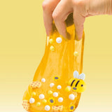 Yellow slime being stretched with bee, flower and white decorations