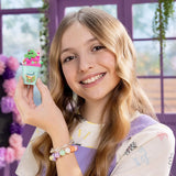 Smiling girl holding a turquoise So Slime Flower Shop Desert pot filled with bright pink slime, miniature green cactus decoration and small colourful flower pieces.